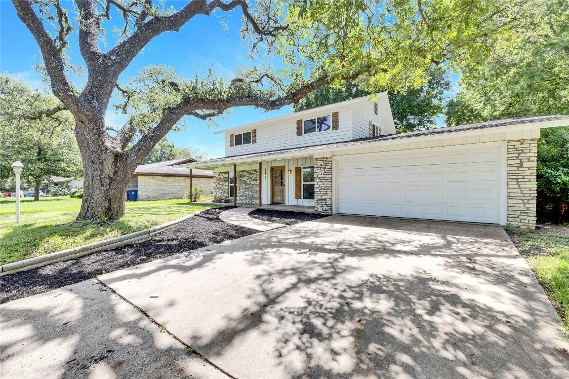 3306 South Pleasant Valley Road Austin, TX 78741 - Photo 5 of 28 a front view of a house with a yard and garage