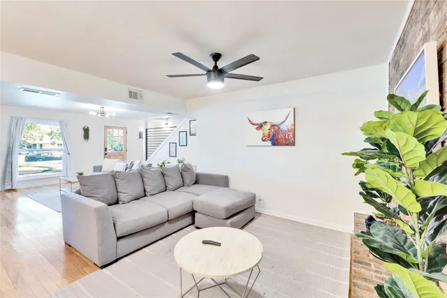 a living room with furniture and a potted plant