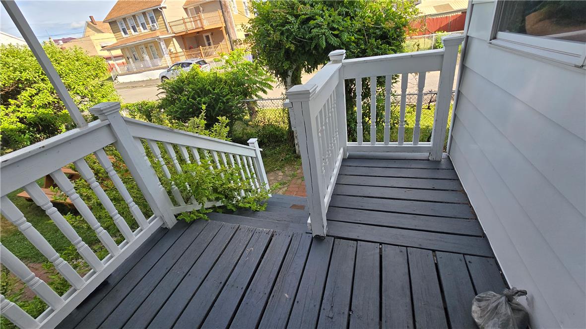 883 North Locust Street Hazleton, PA 18201 - Photo 24 of 83 A welcoming front porch features painted wood decking and classic white railings, inviting entry.