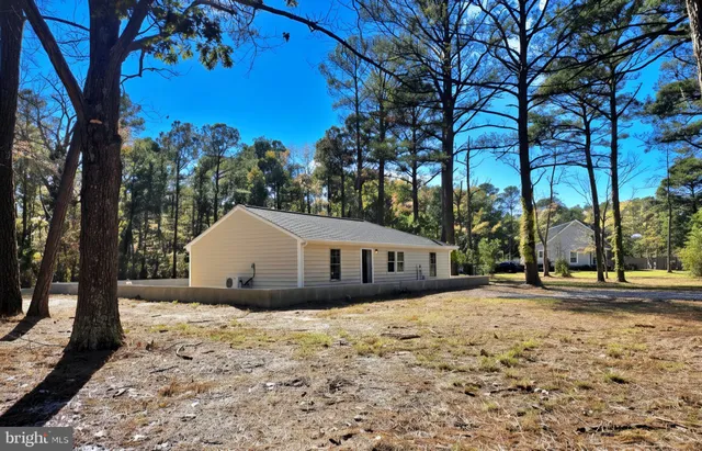 a view of large house with a yard and tree