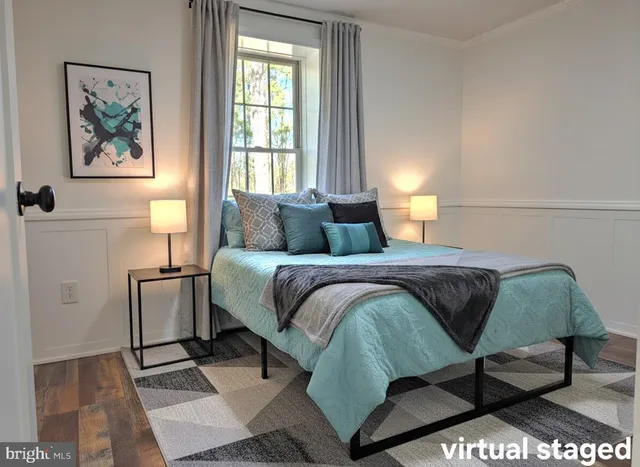 a bedroom with a bed and a painting on the wall