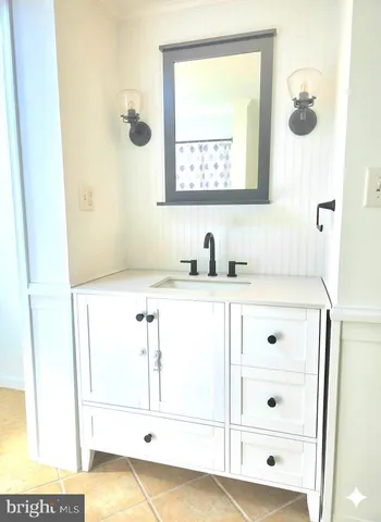 a bathroom with a sink a mirror a vanity and window