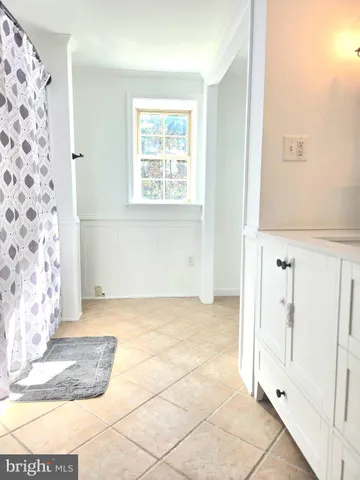 a view of a livingroom with wooden floor and a window