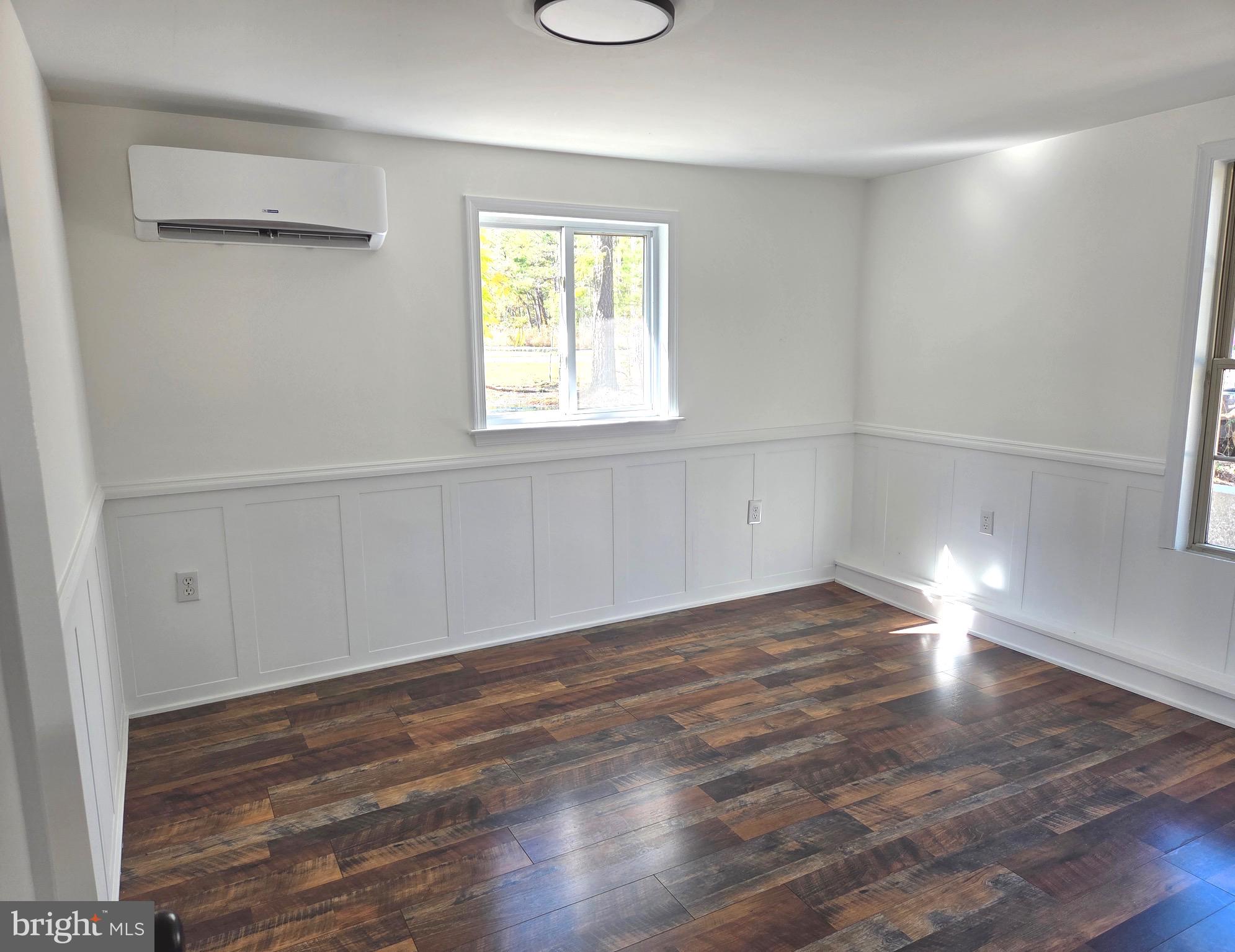 927 Susquehanna Road Madison, MD 21648 - Photo 19 of 26 an empty room with wooden floor and windows