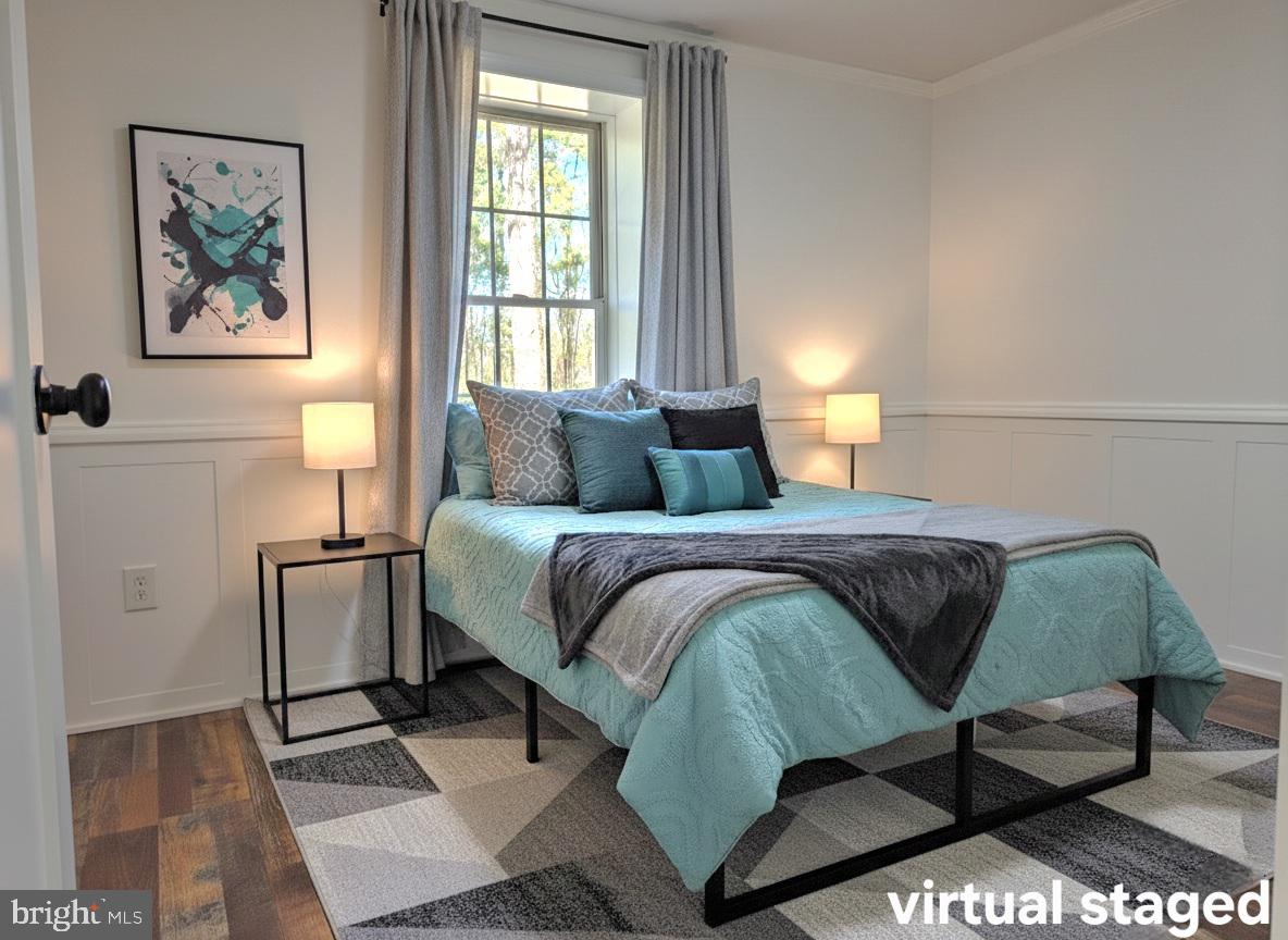 927 Susquehanna Road Madison, MD 21648 - Photo 20 of 26 a bedroom with a bed and a painting on the wall