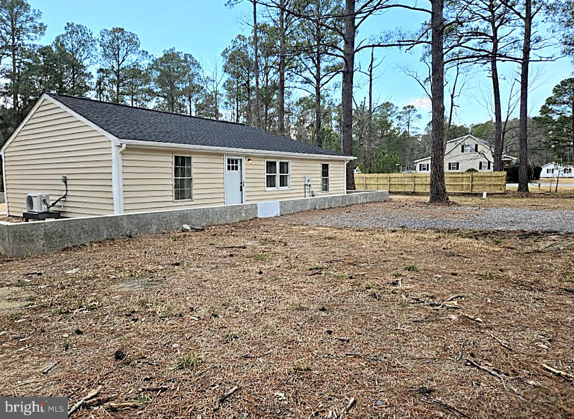 927 Susquehanna Road Madison, MD 21648 - Photo 2 of 26 a backyard of a house with large trees and barbeque oven