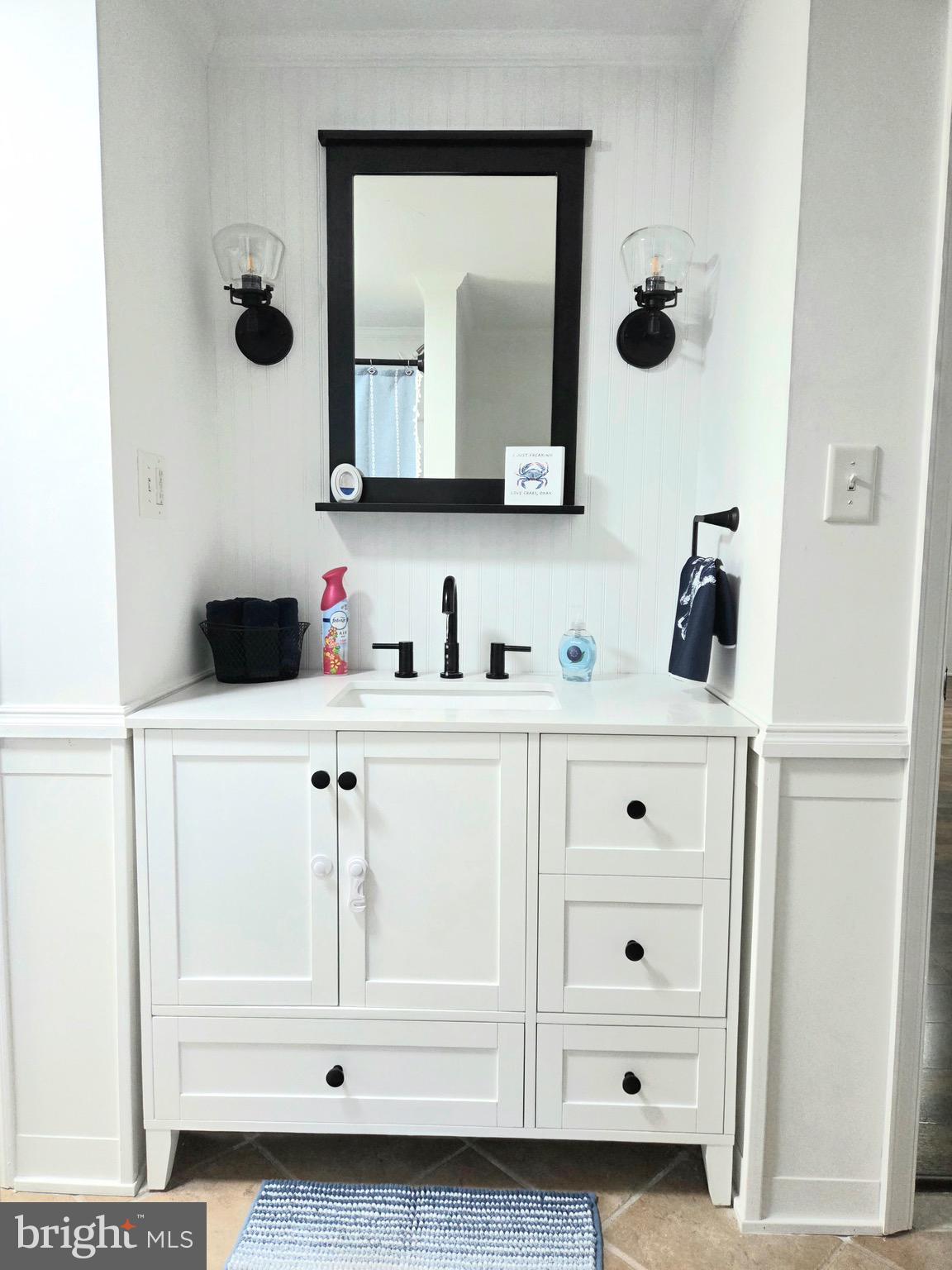 927 Susquehanna Road Madison, MD 21648 - Photo 22 of 26 a bathroom with a vanity and mirror