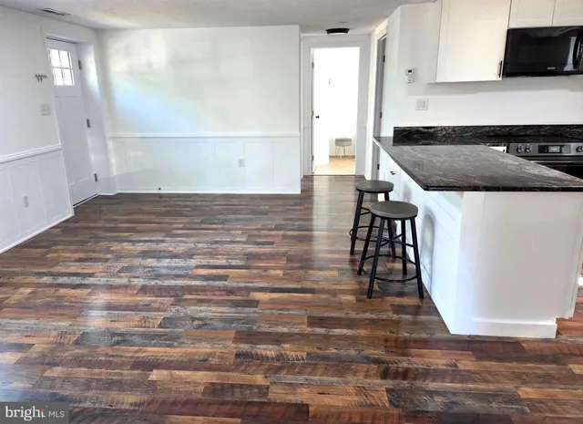 a kitchen with granite countertop a stove and a refrigerator