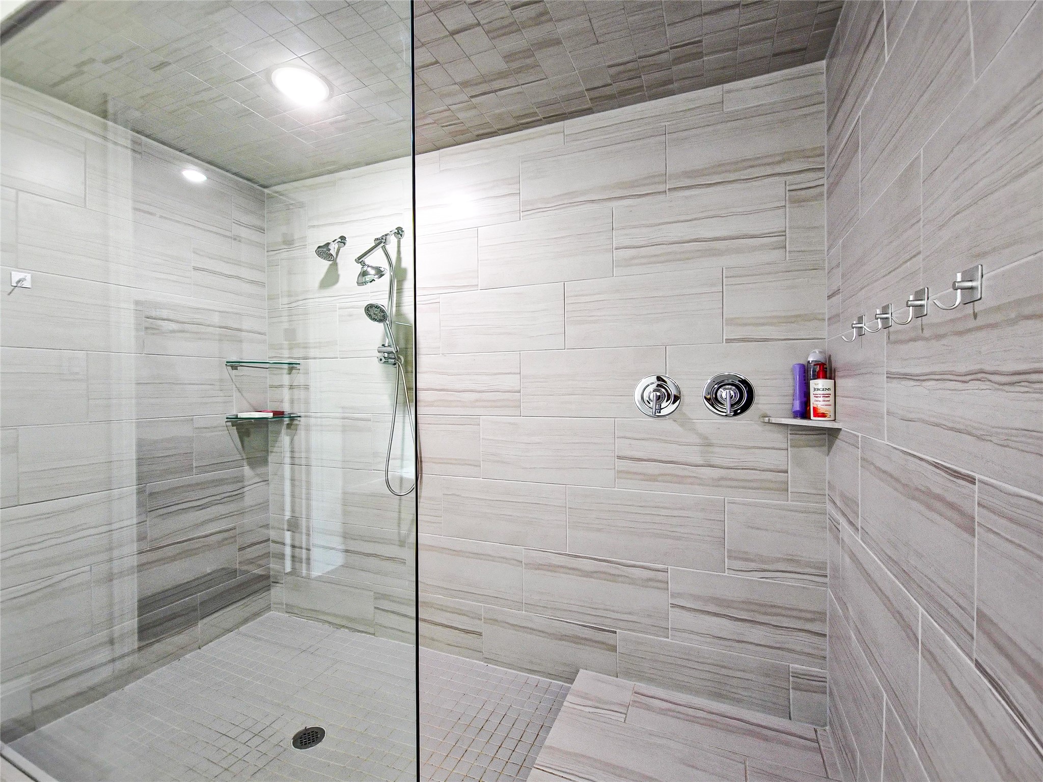 813 Sunny Ridge Drive Leander, TX 78641 - Photo 25 of 32 Step into this contemporary walk-in shower with sleek glass panels and elegant tile work.