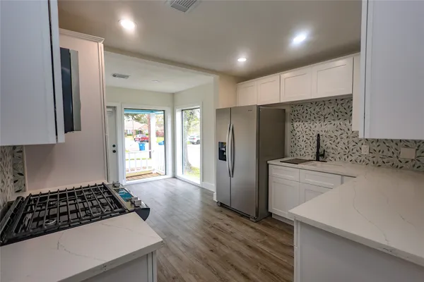 a kitchen with stainless steel appliances a refrigerator stove and sink