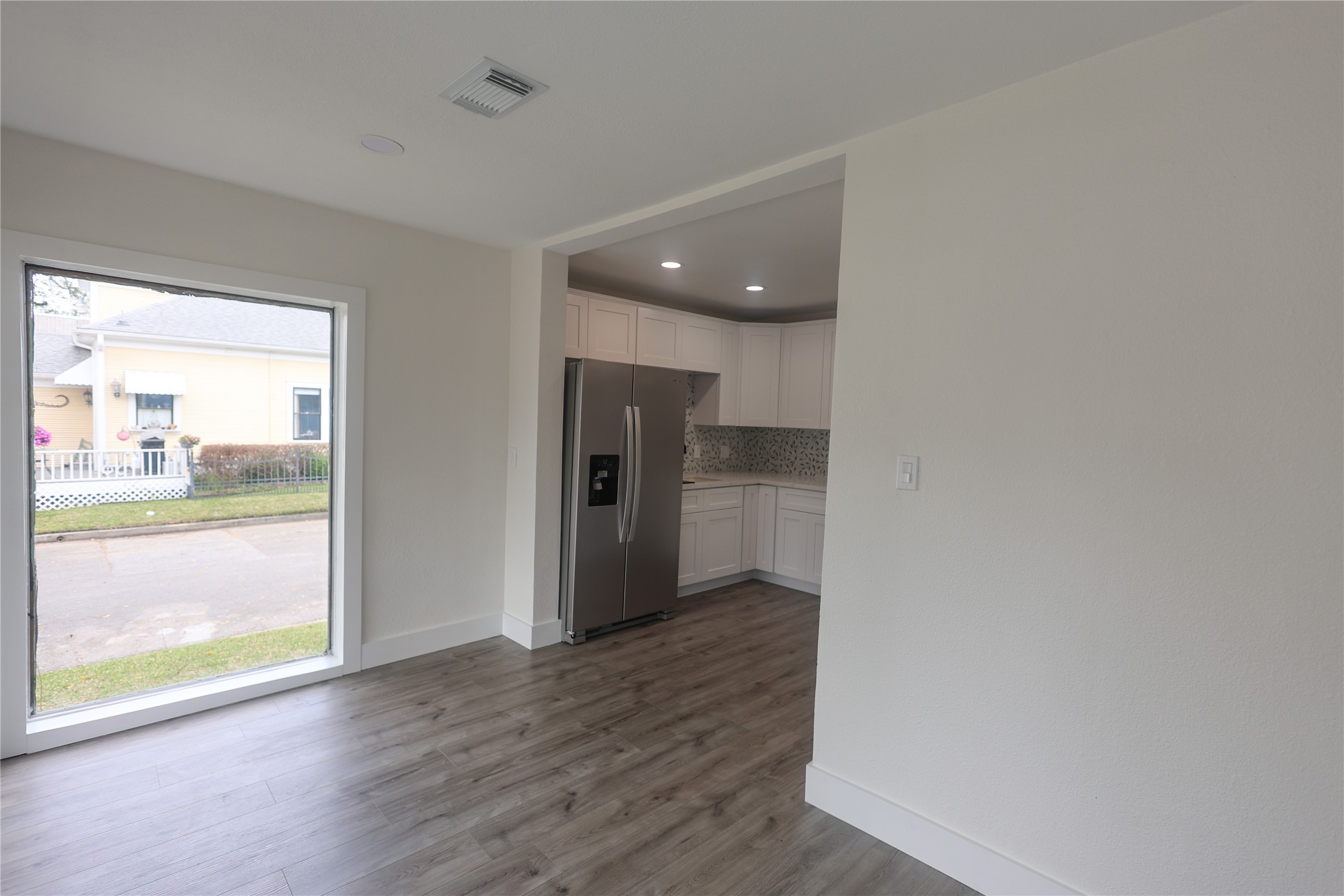 602 Higgins Street Humble, TX 77338 - Photo 15 of 39 wooden floor in an empty room with a window