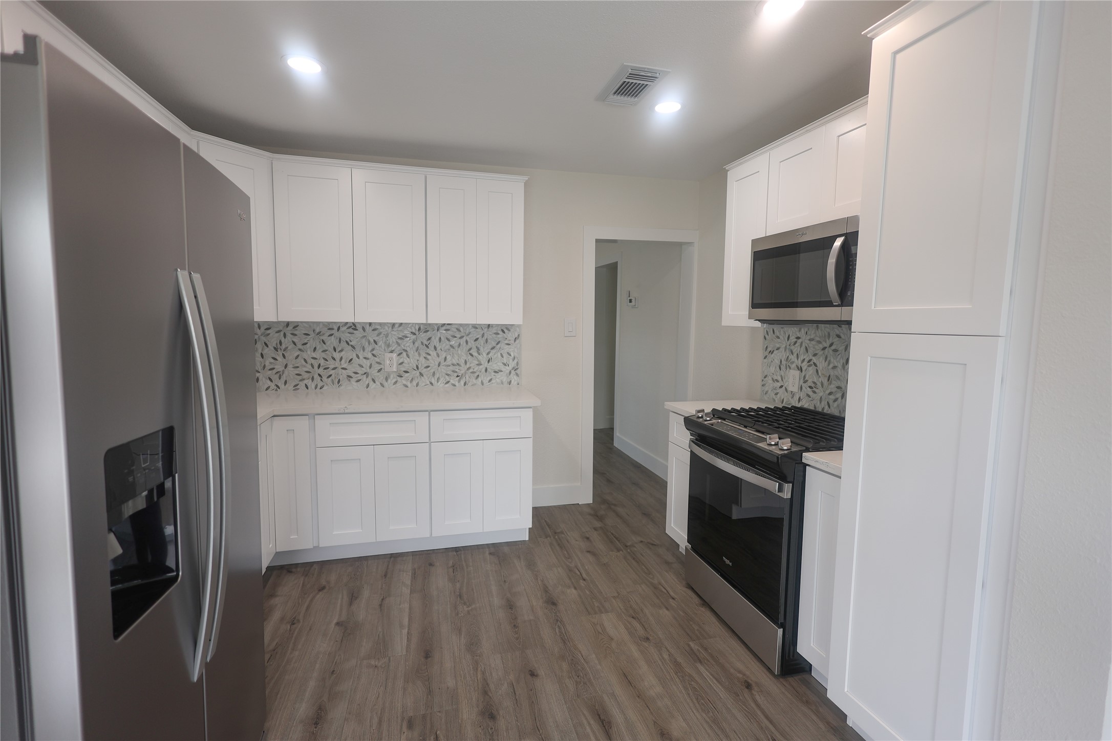 602 Higgins Street Humble, TX 77338 - Photo 16 of 39 a kitchen with granite countertop a refrigerator stove and microwave