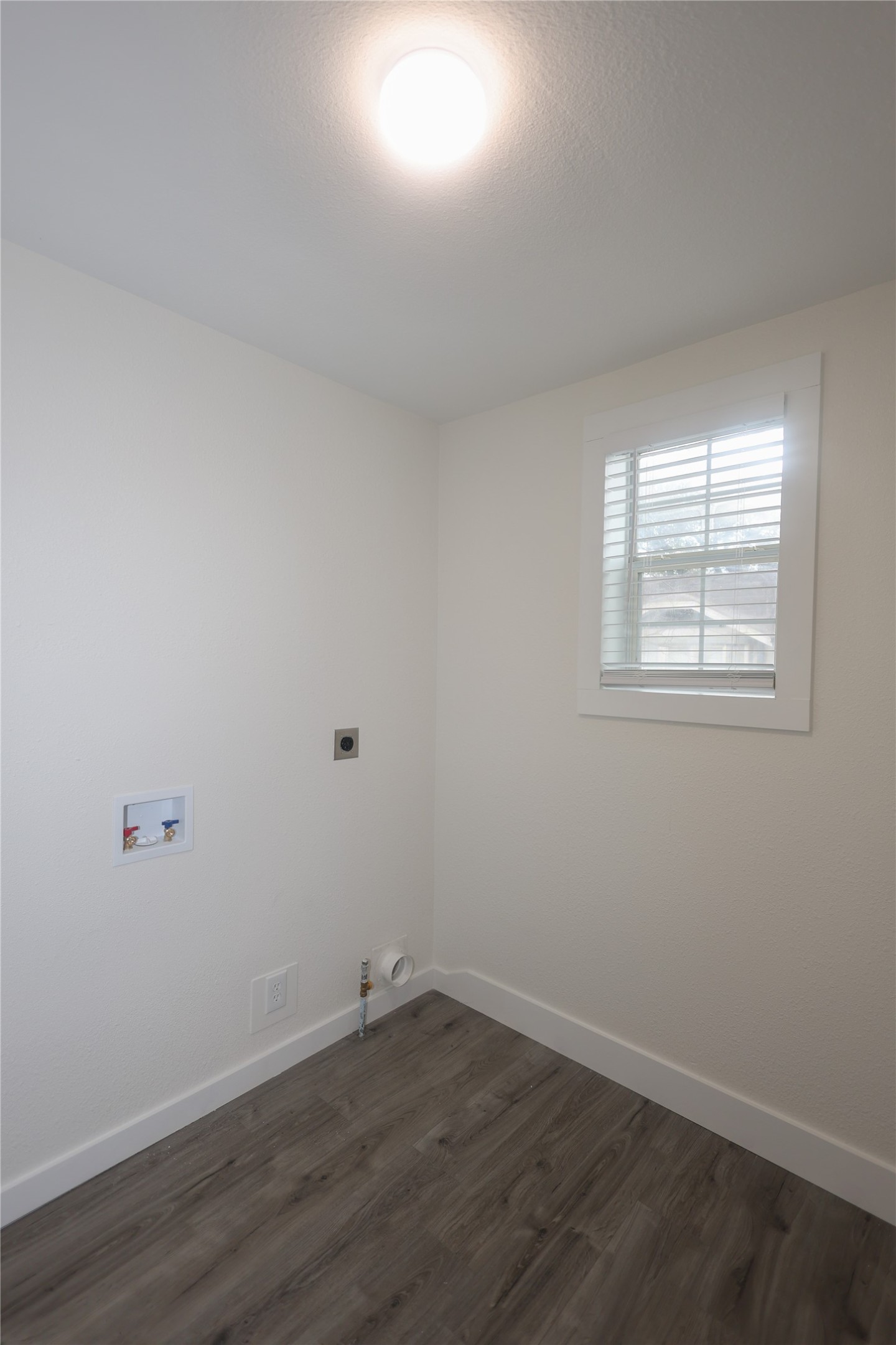 602 Higgins Street Humble, TX 77338 - Photo 17 of 39 an empty room with wooden floor and windows