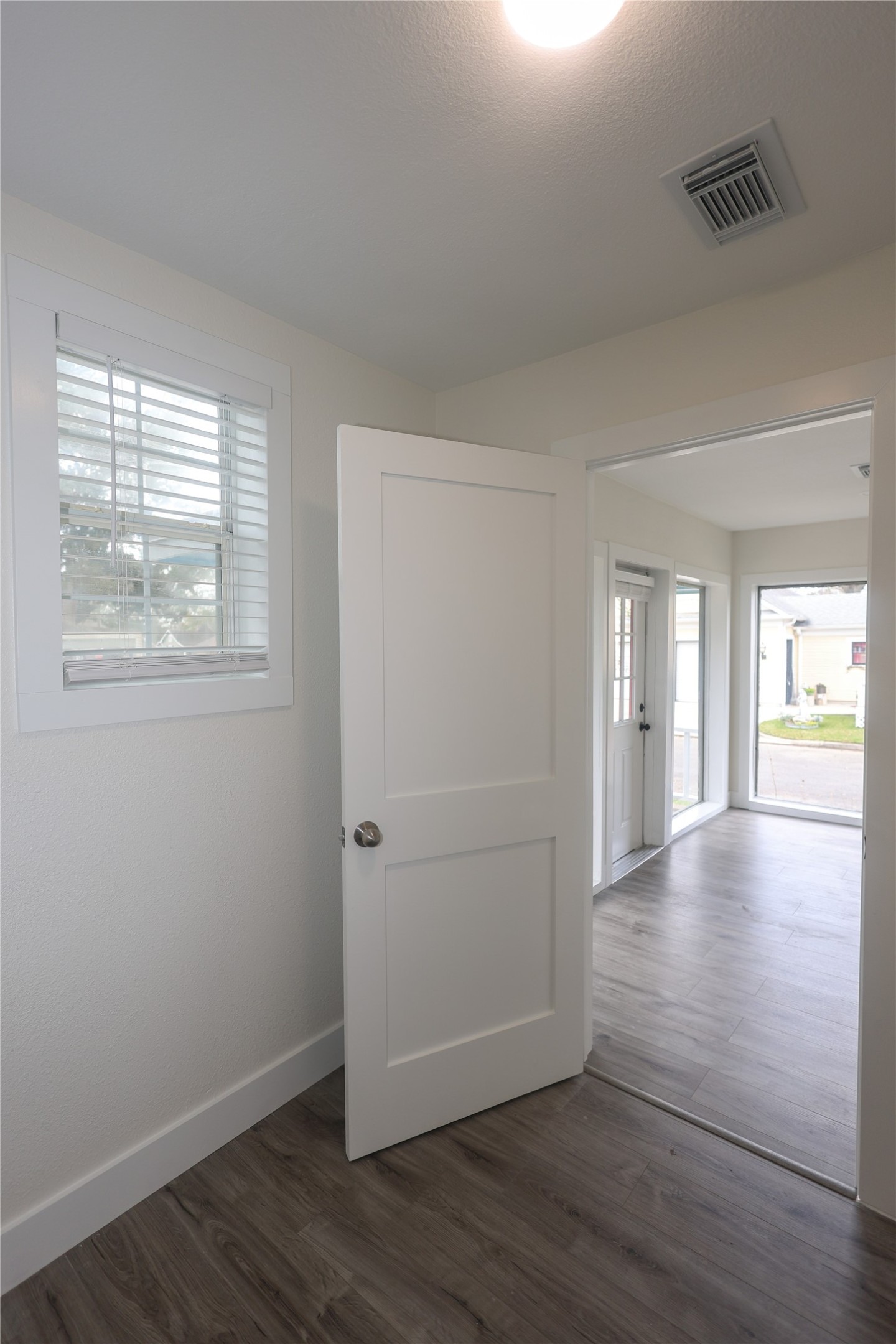 602 Higgins Street Humble, TX 77338 - Photo 18 of 39 an empty room with wooden floor and windows