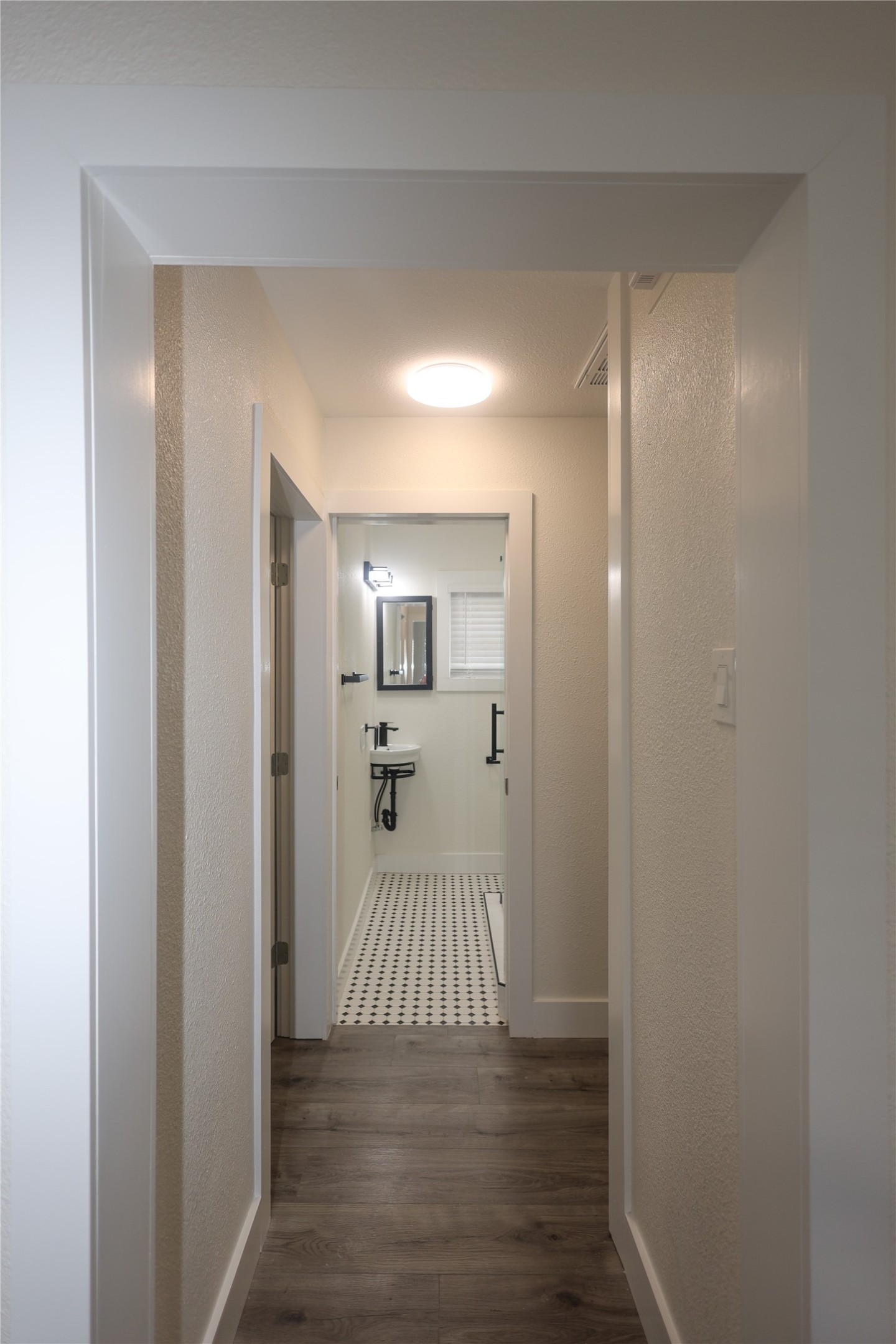 602 Higgins Street Humble, TX 77338 - Photo 20 of 39 a view of a room with wooden floor white walls and stairs