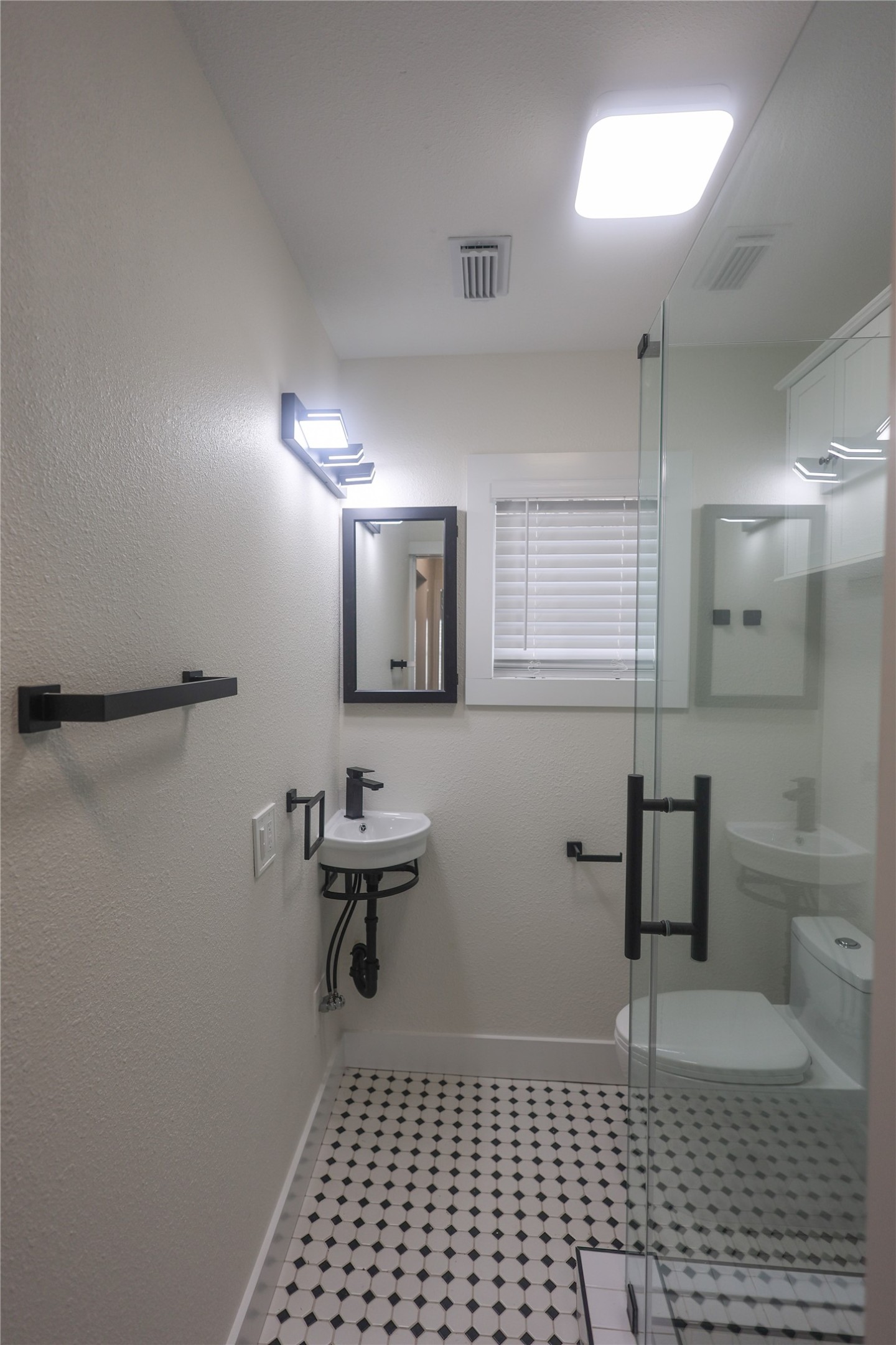 602 Higgins Street Humble, TX 77338 - Photo 21 of 39 a bathroom with a sink a toilet a mirror and shower