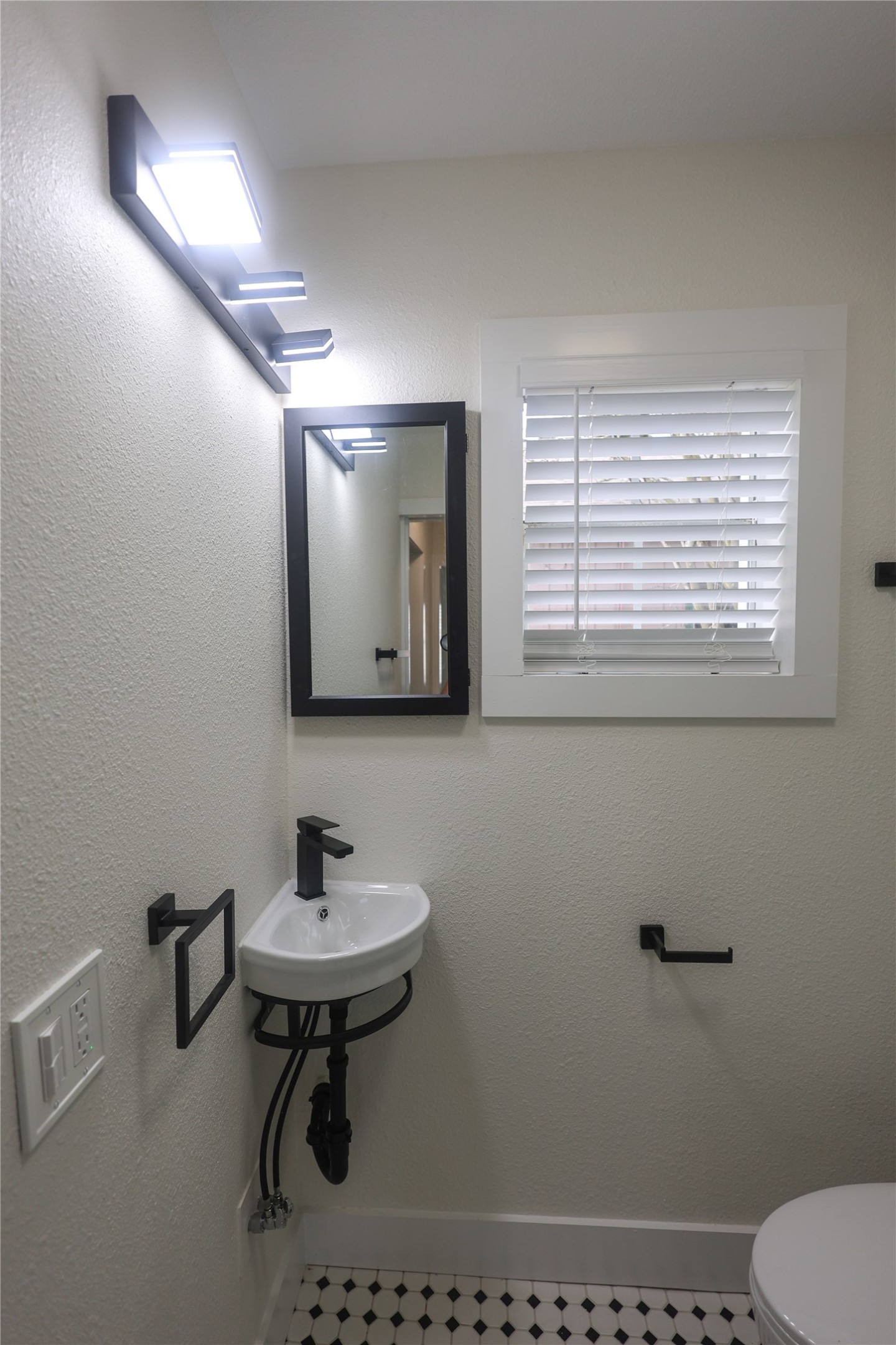 602 Higgins Street Humble, TX 77338 - Photo 23 of 39 a bathroom with a sink a toilet and a mirror