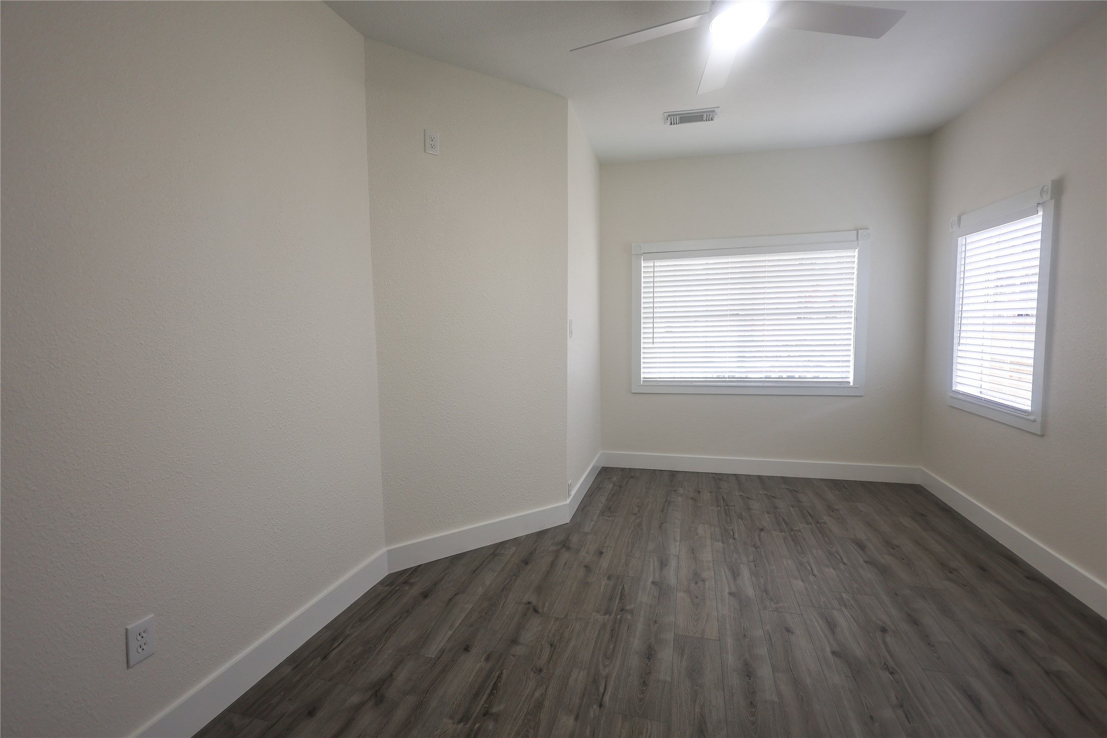 602 Higgins Street Humble, TX 77338 - Photo 27 of 39 an empty room with wooden floor and windows