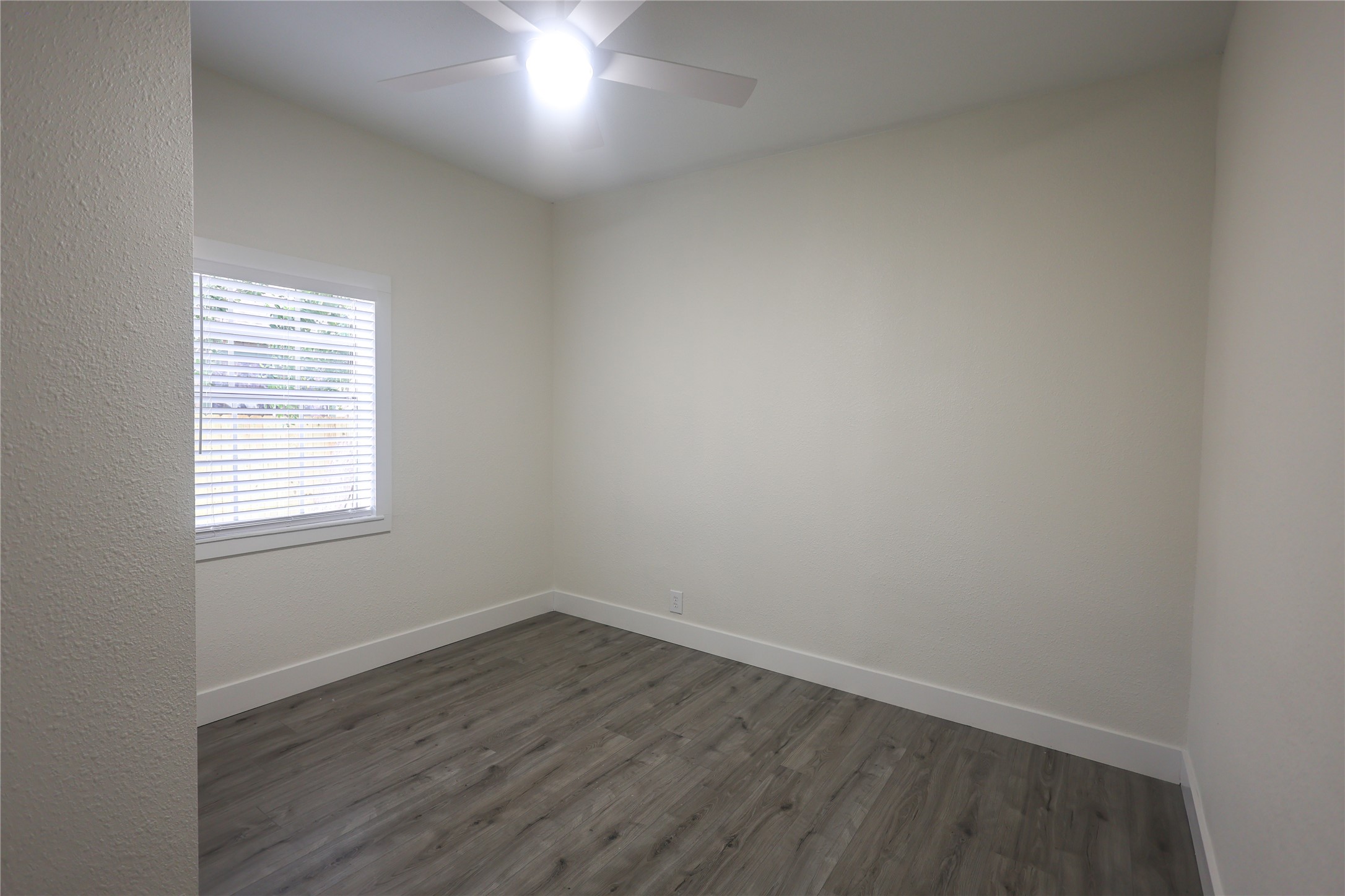 602 Higgins Street Humble, TX 77338 - Photo 28 of 39 an empty room with wooden floor and windows
