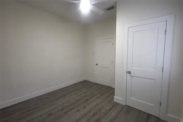 a view of small space with wooden floor and closet