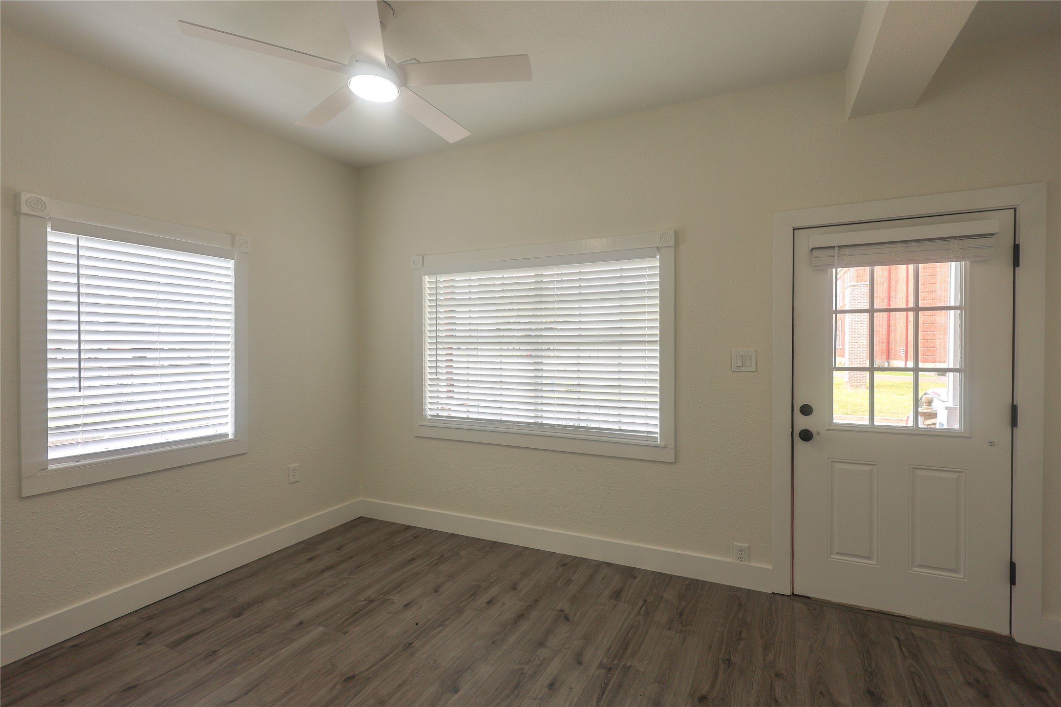 602 Higgins Street Humble, TX 77338 - Photo 5 of 39 an empty room with wooden floor and windows