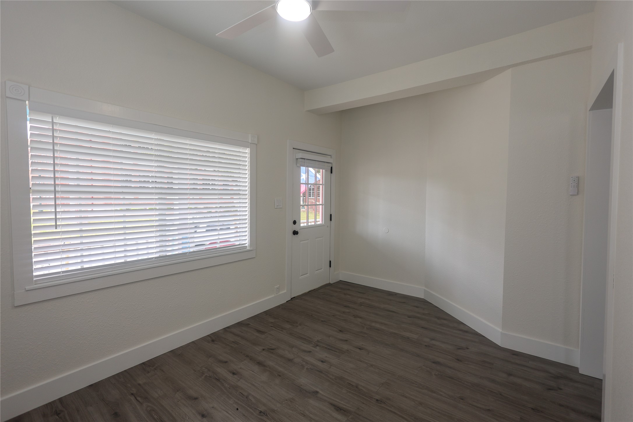 602 Higgins Street Humble, TX 77338 - Photo 7 of 39 an empty room with wooden floor and windows