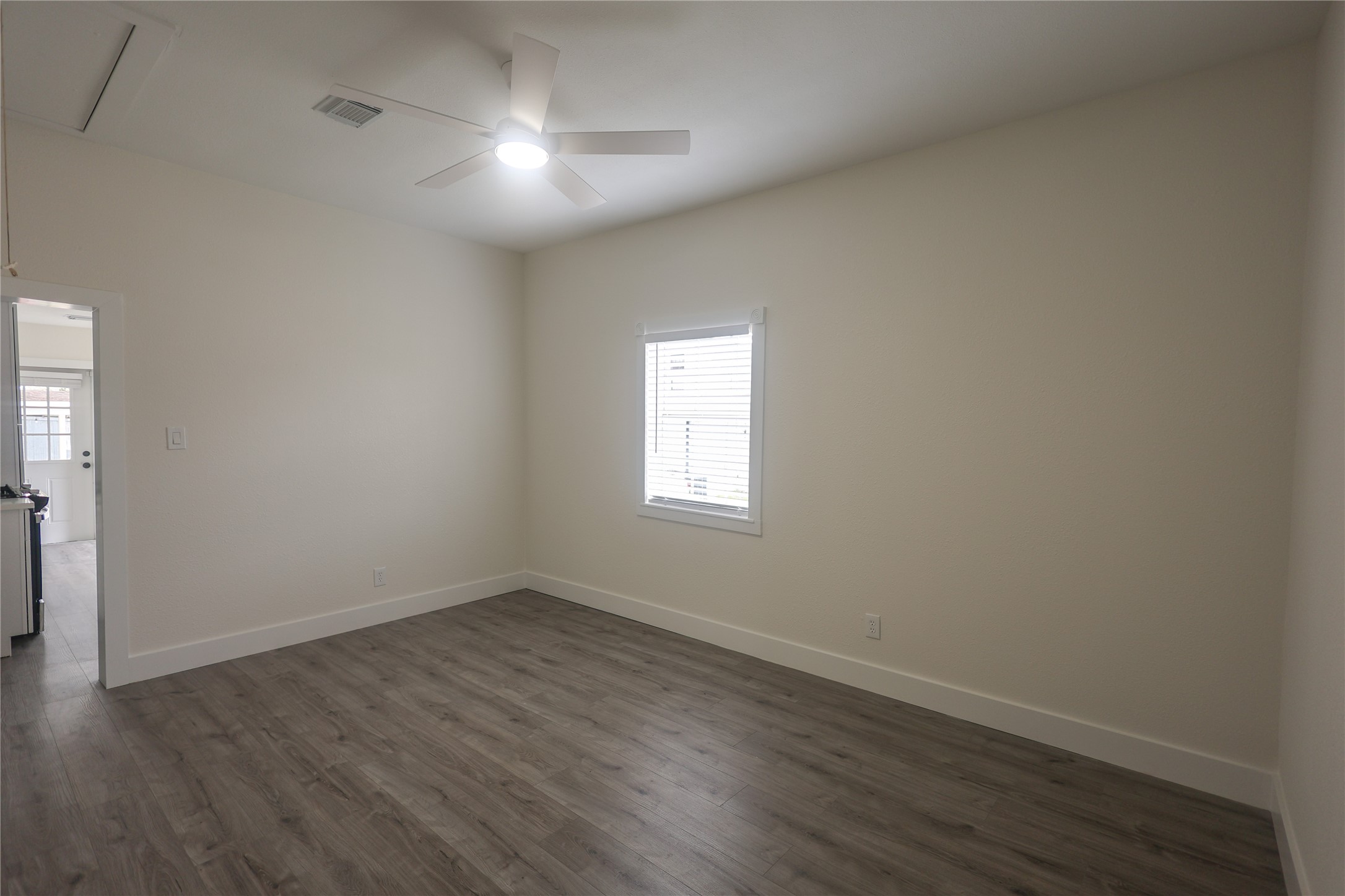 602 Higgins Street Humble, TX 77338 - Photo 8 of 39 wooden floor in an empty room with a window