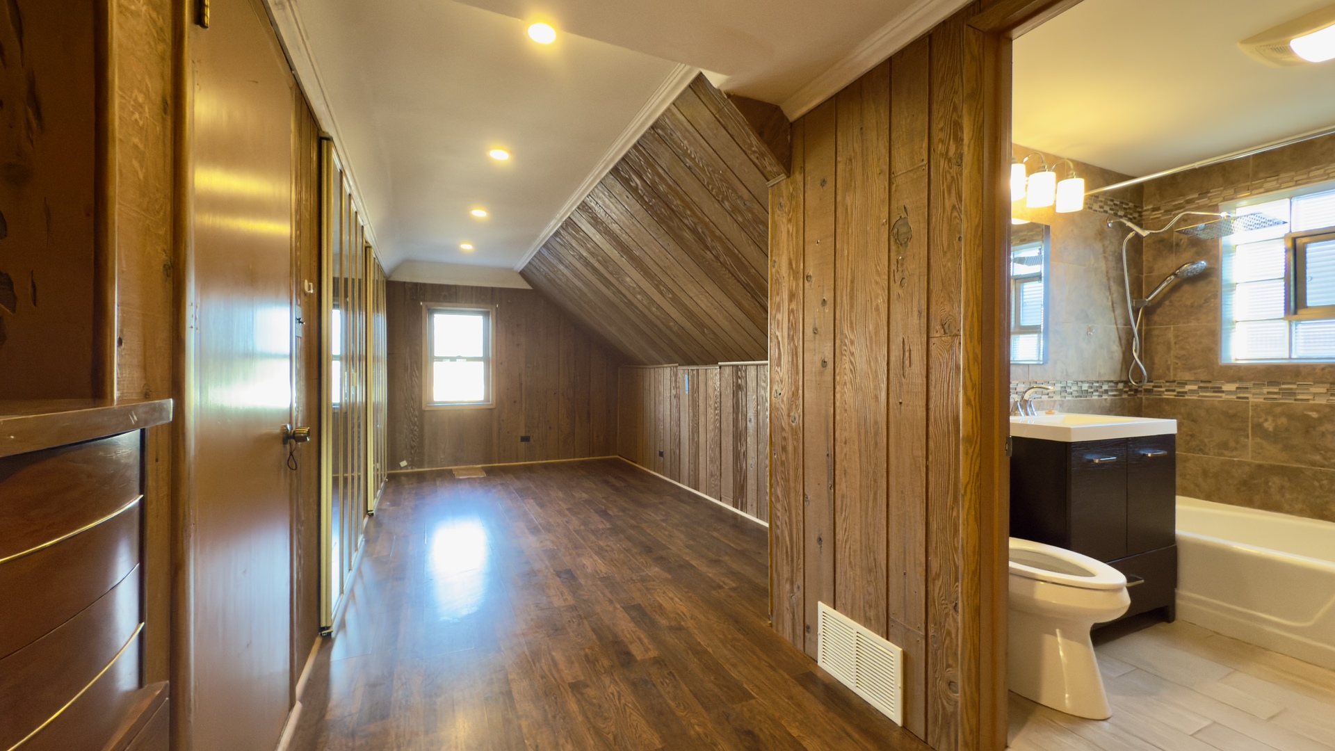 7127 South Ridgeway Avenue Chicago, IL 60629 - Photo 17 of 28 a view of a hallway with wooden floor and a bathroom
