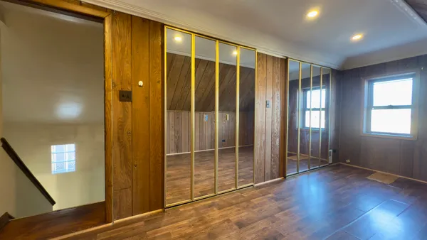 a view of gallery with wooden floor
