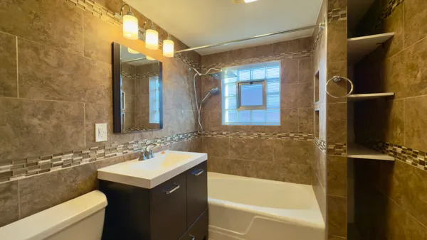 a bathroom with a sink toilet and shower