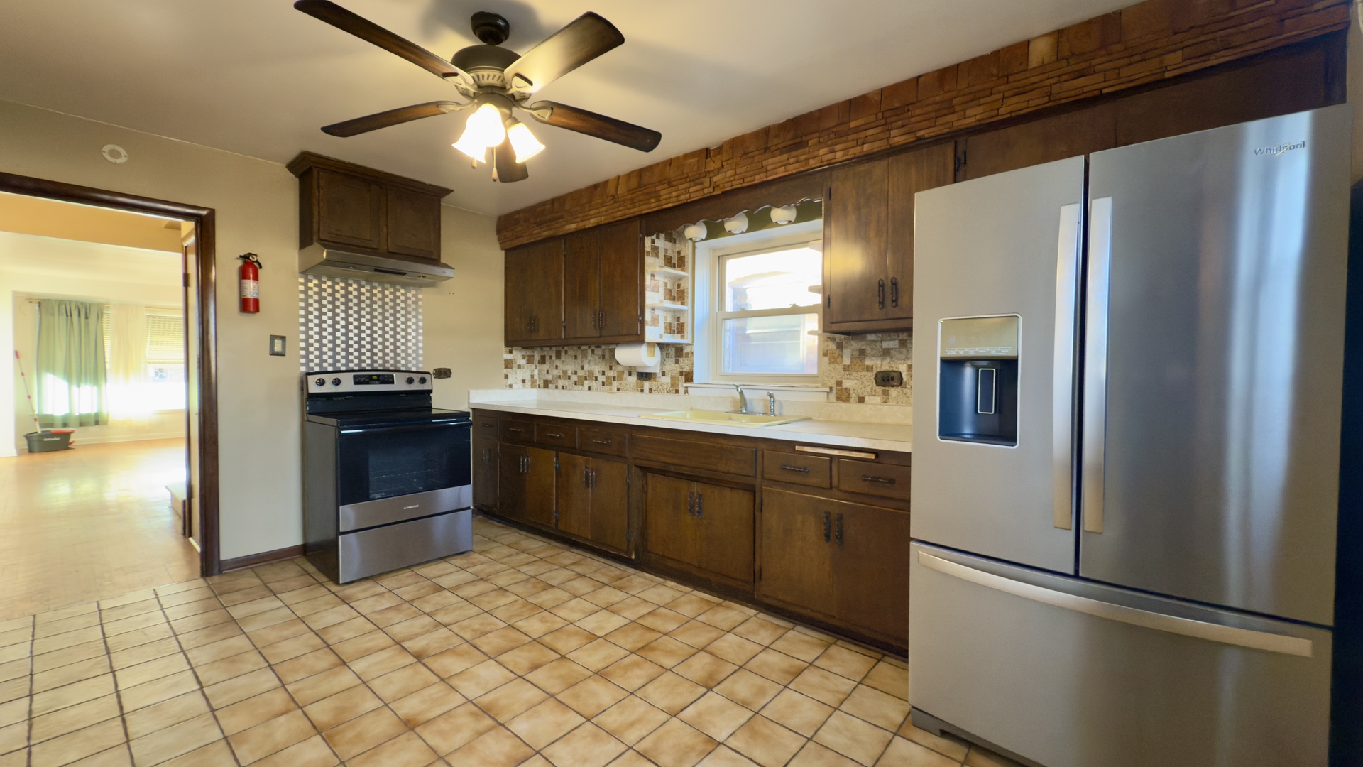 7127 South Ridgeway Avenue Chicago, IL 60629 - Photo 5 of 28 a kitchen with stainless steel appliances a refrigerator and a sink