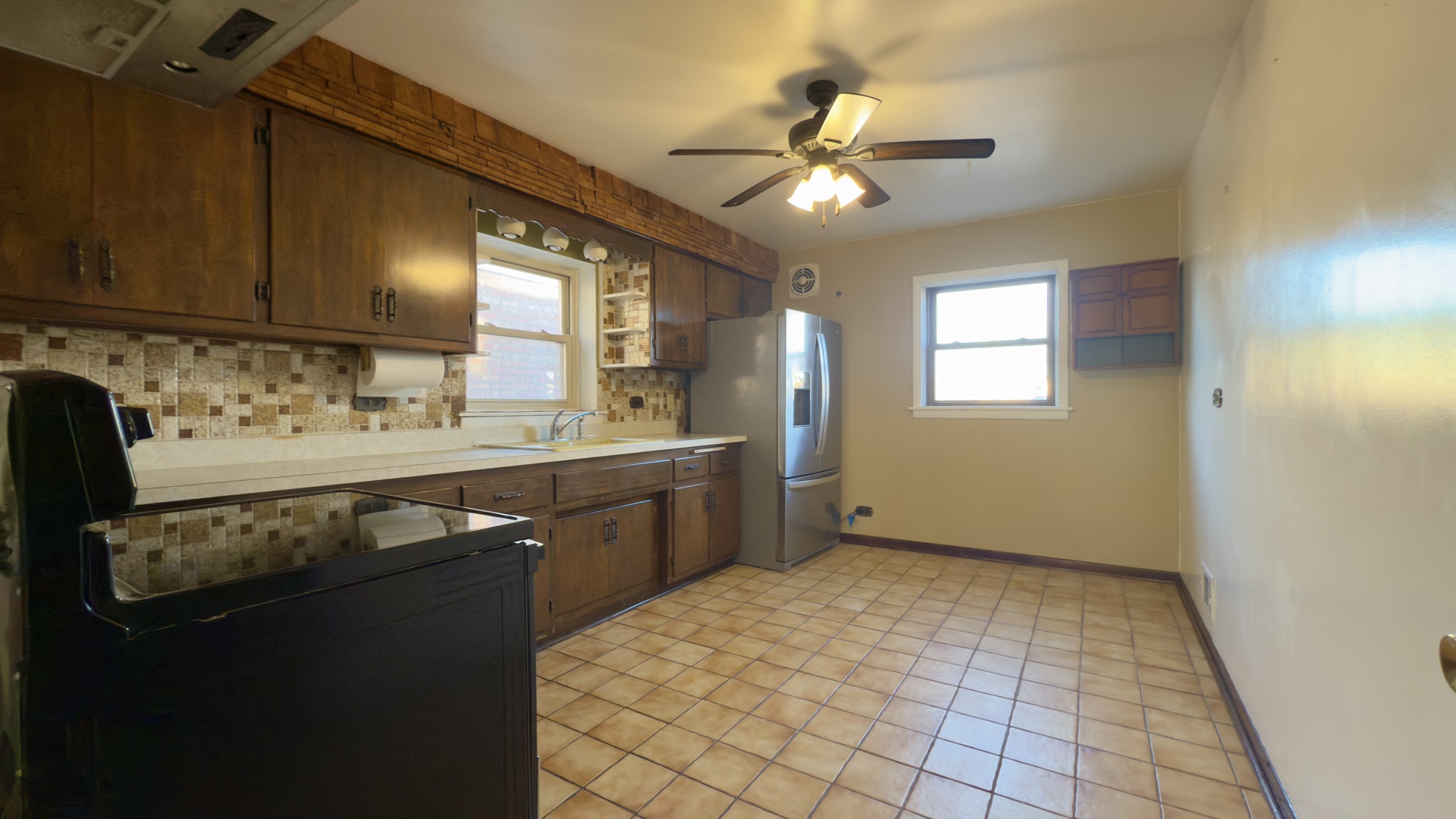 7127 South Ridgeway Avenue Chicago, IL 60629 - Photo 6 of 28 a kitchen with a sink a stove cabinets and a window