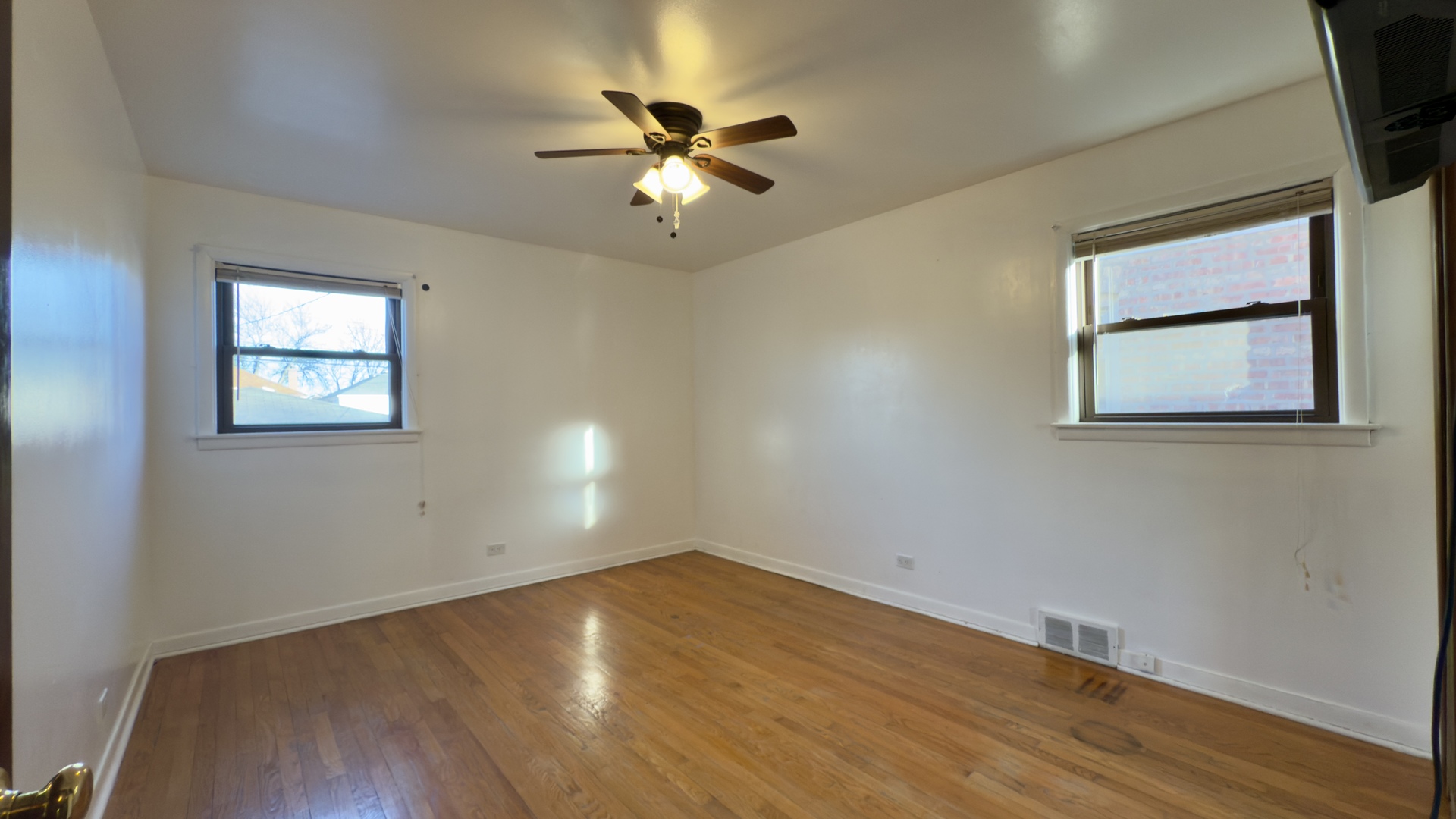 7127 South Ridgeway Avenue Chicago, IL 60629 - Photo 8 of 28 a view of an empty room with wooden floor and a window