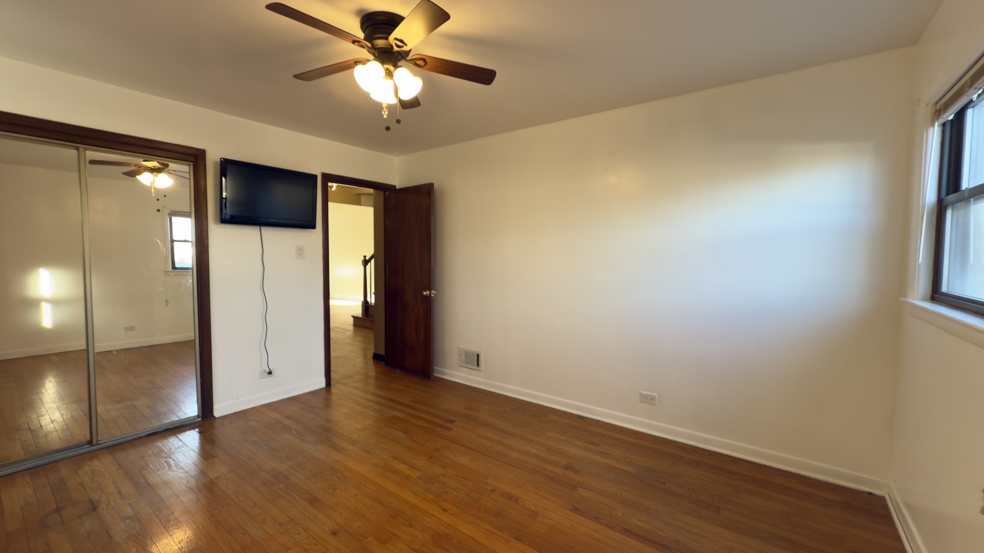 7127 South Ridgeway Avenue Chicago, IL 60629 - Photo 9 of 28 wooden floor in an empty room with a window