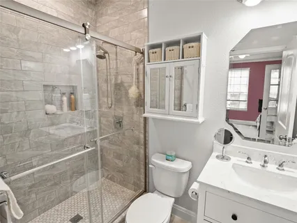 a bathroom with a sink toilet and shower