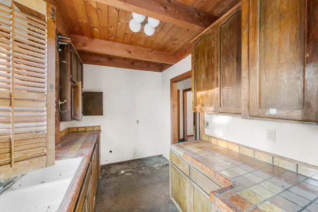 a kitchen with cabinets and window