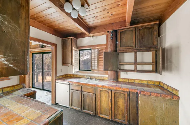 a bathroom with a granite countertop sink and a large mirror