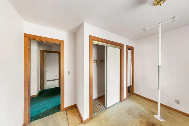 a view of a bedroom with table and chair