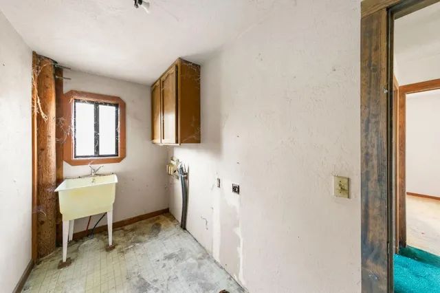 a bathroom with a granite countertop sink a toilet and shower