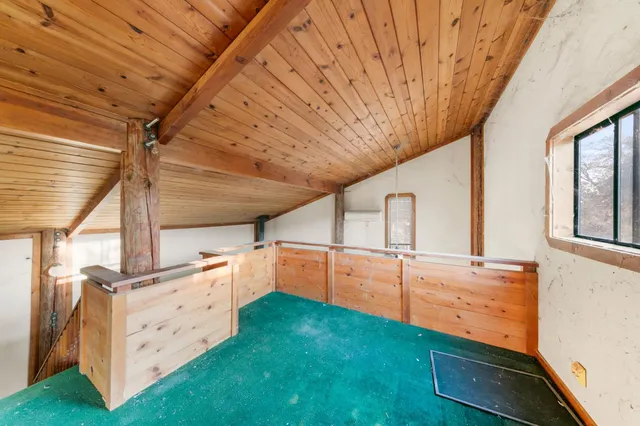 a view of an empty room with window and cabinet