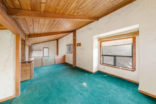 a view of balcony with wooden floor and fence