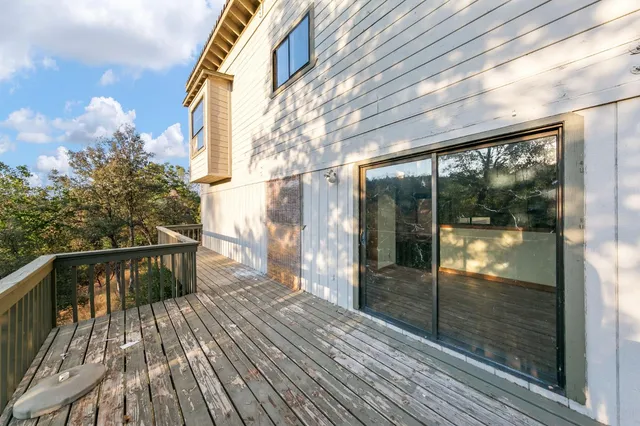 a balcony with wooden floor and fence