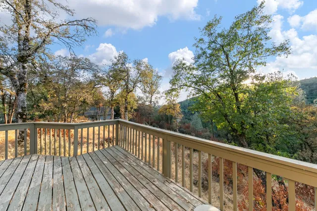 a view of a balcony with wooden floor