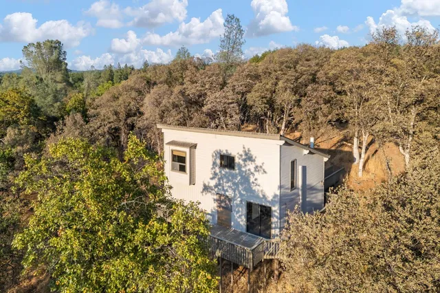 a view of a house with a yard and covered with snow
