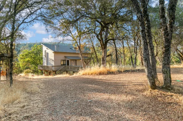 a view of a house with trees in the background