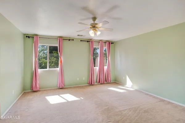 a view of a livingroom with a ceiling fan and window