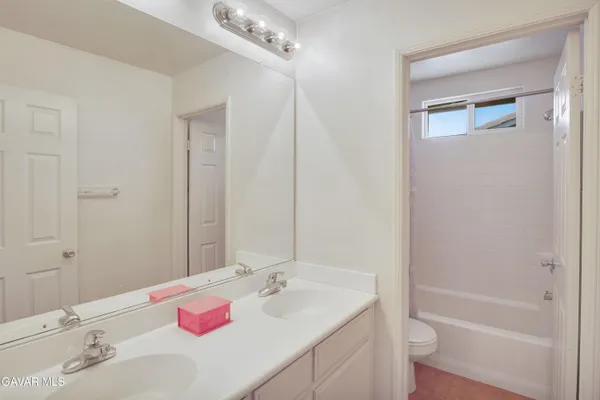 a bathroom with a sink vanity tub and shower