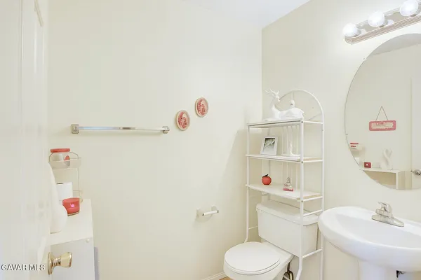 a white toilet sitting next to a bathroom sink