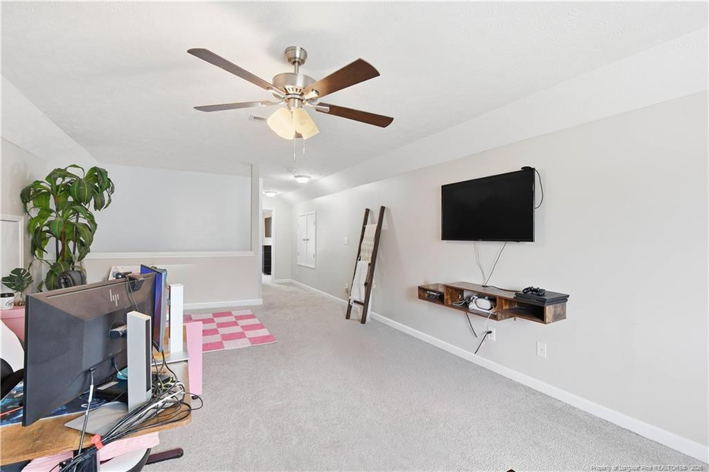 212 Lennox Loop Raeford, NC 28376 - Photo 34 of 47 a living room with furniture and a flat screen tv