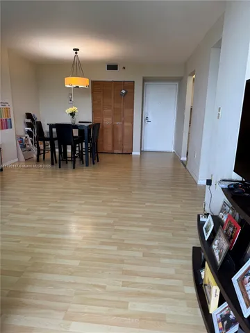 an empty room with fireplace and chandelier